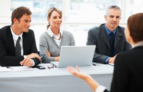 A group of people sitting around a table

AI-generated content may be incorrect.